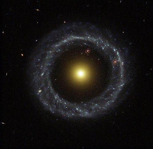 Ring of Hot Blue Stars Pinwheels Around Yellow Nucleus of Hoag's Object Galaxy (NASA) Hs-2002-21-a-large web