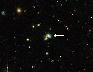 A view of newly-discovered Green Bean galaxy J2240. J2240 lies in the constellation of Aquarius (The Water Bearer) and is about 3.7 billion light years from Earth. Image Credit: CFHT/ESO/M. Schirmer