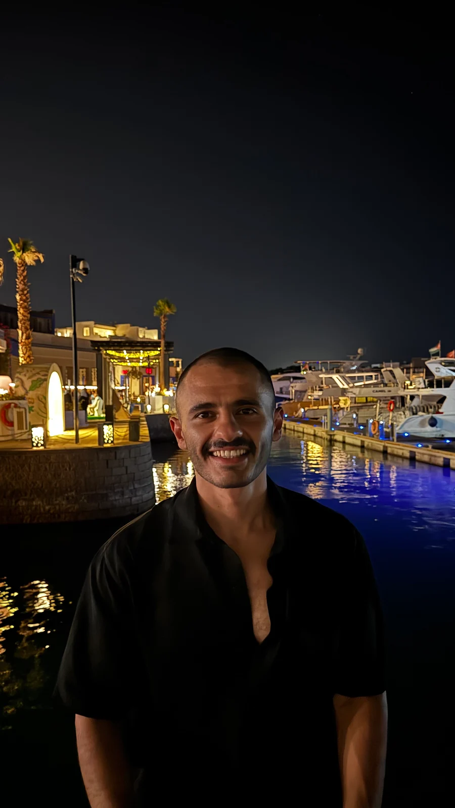 Anas Nassar smiling by a marina