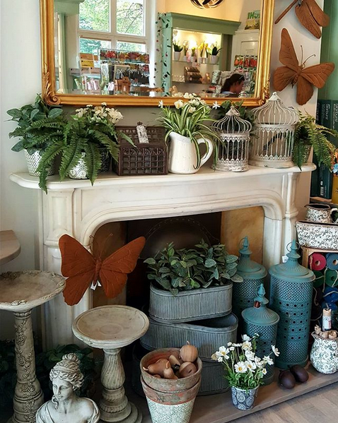 A selection of products available at the Garden Shop, such as pots, lanterns, wall decorations and bird baths.