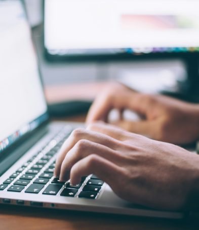 Person typing at keyboard.