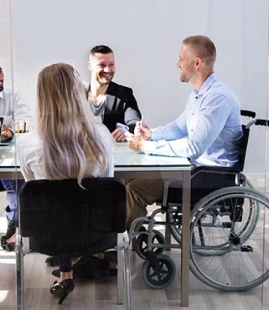 A man in a wheelchair with a group of people.