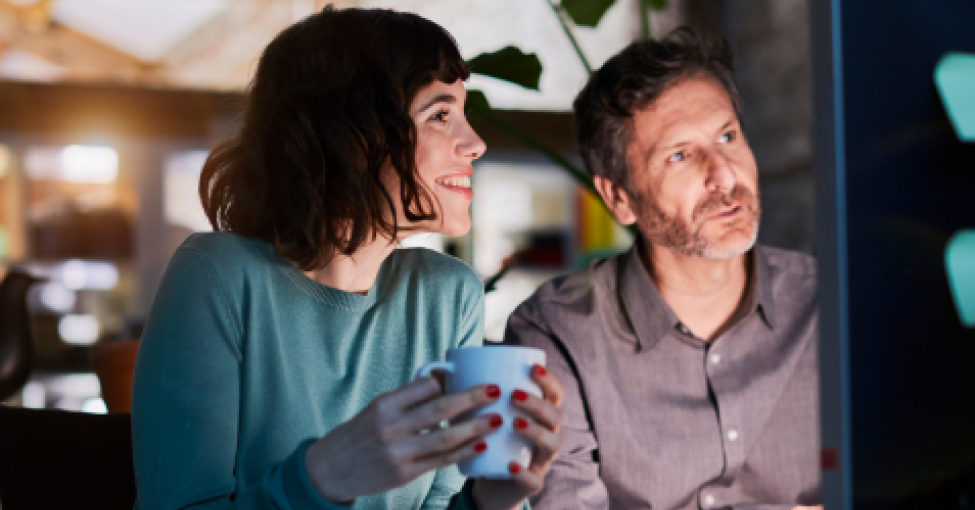 Two people looking at a screen