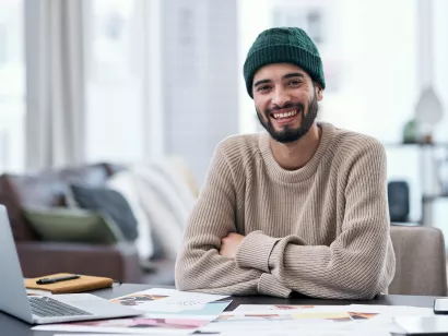 Mannlig student som sitter og smiler