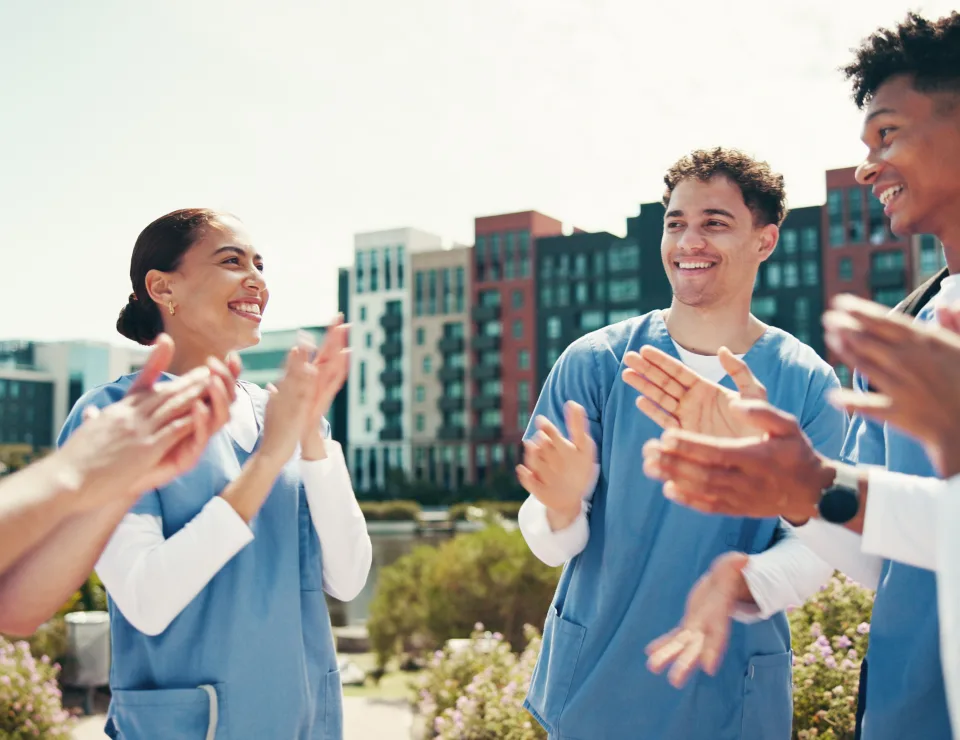 Medical success, students and happy with applause outdoor for health training feedback or board exa.