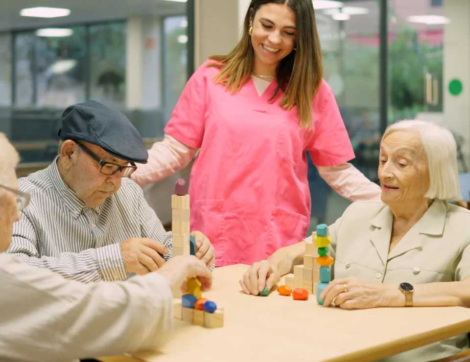 Friendly nurse talking to senior people in the nursing home