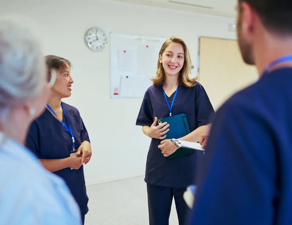 Doctors and nurses collaborating, sharing expertise, and coordinating patient care during a productive meeting in a modern hospital setting