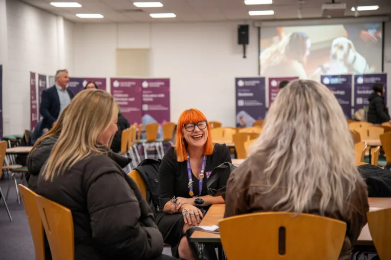 Photo taken during an Open Day: an academic is chatting with a prospective student in the subject marketplace.