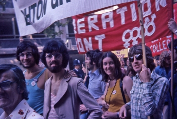 Image from our collections of some people holding signs at a protest.