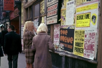 Two women reading posters