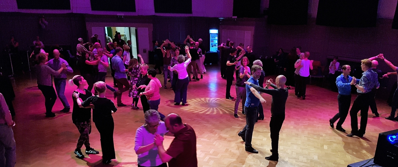 Image from our collections of some ballroom dancers in the Great Hall. View is from the stage.