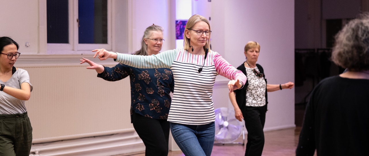 Image of a group of women dancing in the Upper Hall.