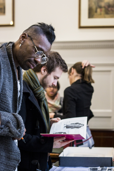 Lemington Ridley, Choreographer and Costume Designer of Ragtime, browsing materials around the show.