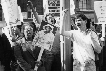 A black and white photo from the protest and campaigning archives. Protestors are holding signs which say: "Black and White, unite and fight", and "Socialist Worker".