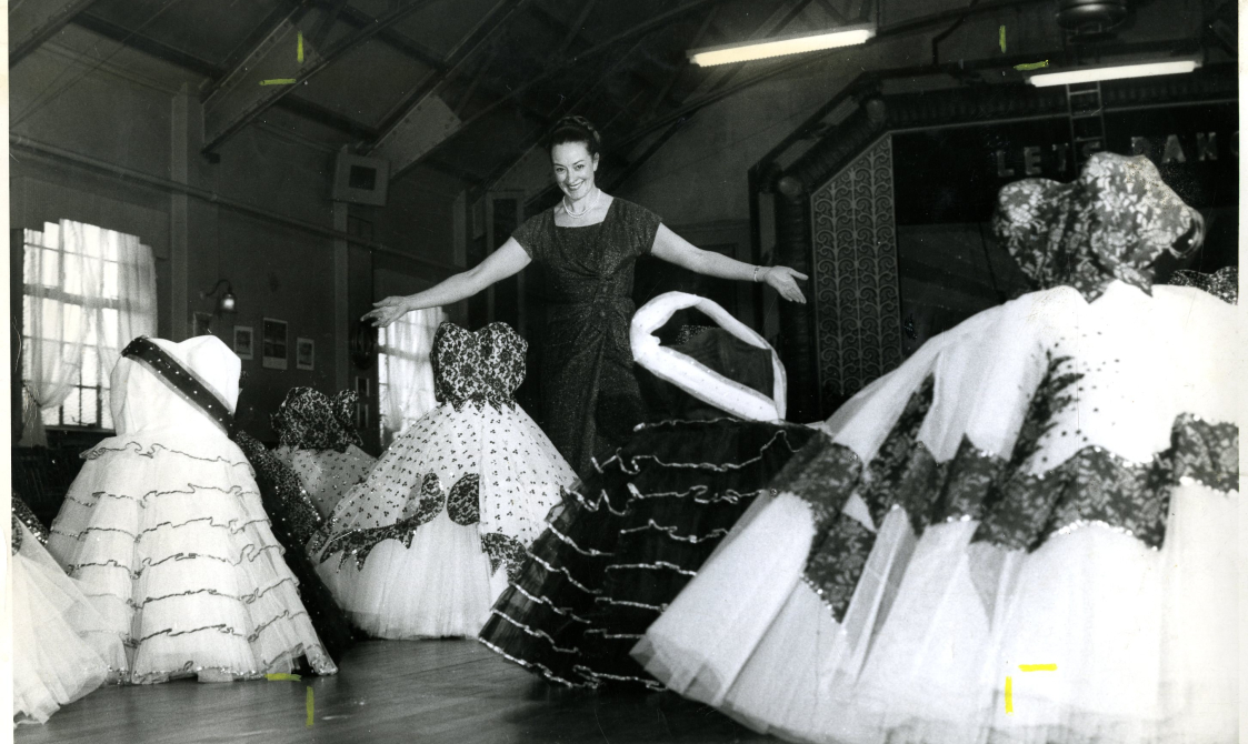 Four dresses are being displayed in this black and white images, with puffy white skirts and white and black bodices.