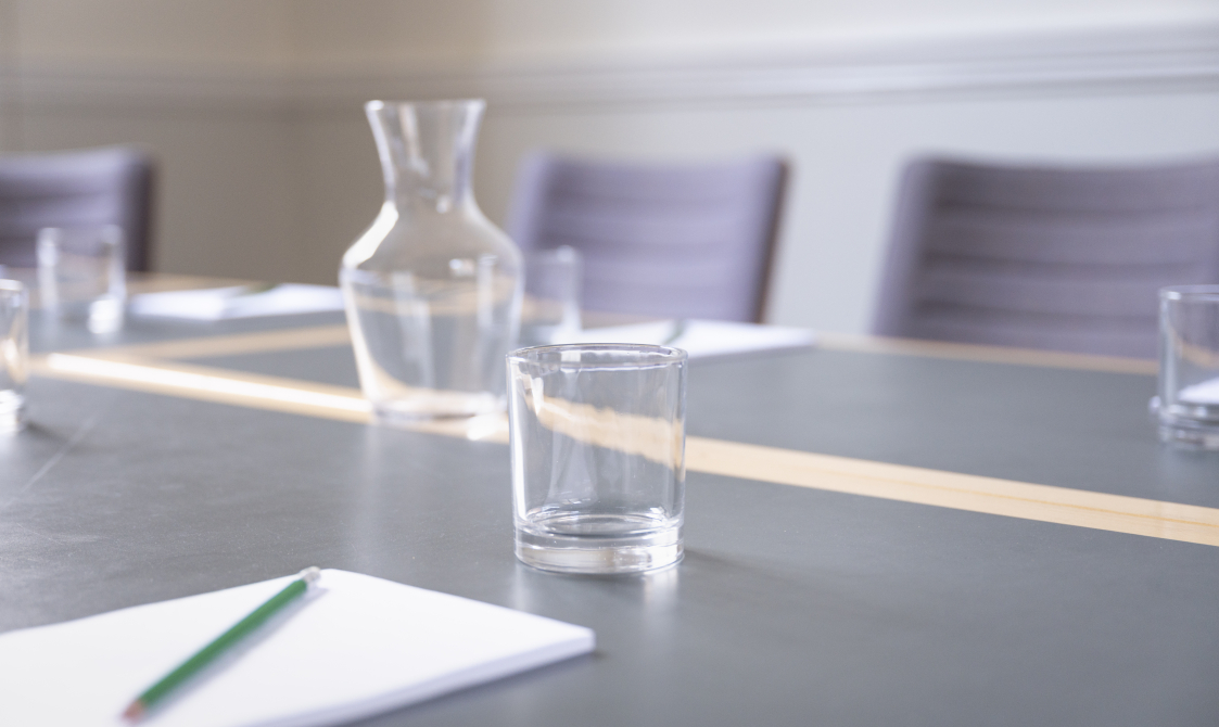 A photograph of Bishopsgate Institute's Townsend Room in central London. The image is focused on a waterjug and glasses on the desk.
