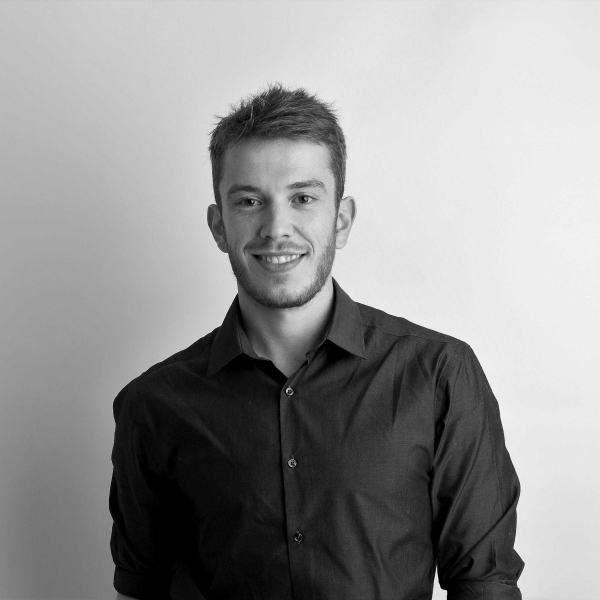 A black and white portrait photo of tutor Clement Guerra.