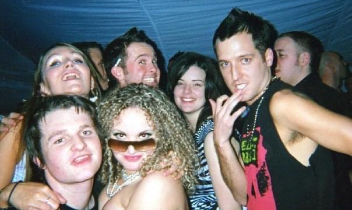 Will and a group of his friends at a Pride party. All looking quite intoxicated and happy.