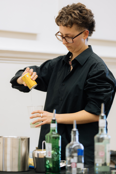 A bartender pours a drink.