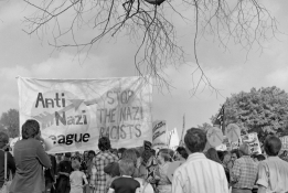 Image from the Robert Workman Archive. Crowd walking in protest holding banner which reads "Anti Nazi League" and "Stop the Nazi racists".