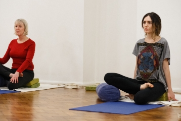 a group taking a Yoga class at Bishopsgate Institute, London