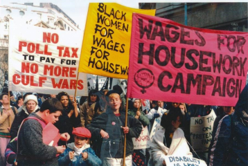 An image of a Wages for Housework protest march, showing women holding Wages for Housework banners.