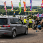 Taxi dropping off people at a festival in the UK