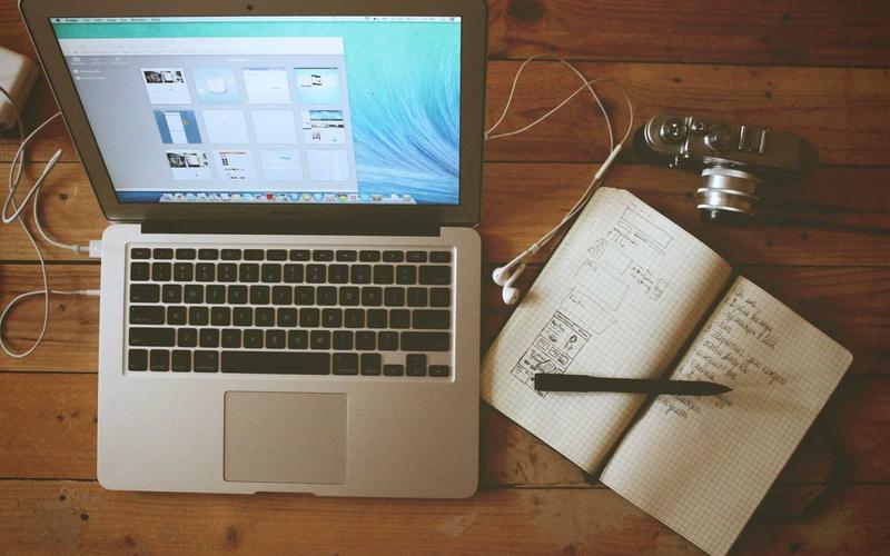 Notebook and laptop on a desk, ready to plan your marketing