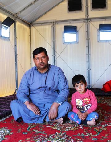 Iraq. Displaced family given shelter on return to damaged village.