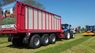 Grass & Muck: 3-axle monster flies flag for wagon fanatics