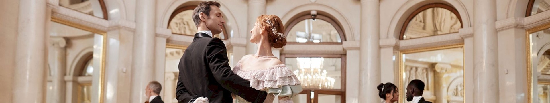 Couples dancing in palace ballroom