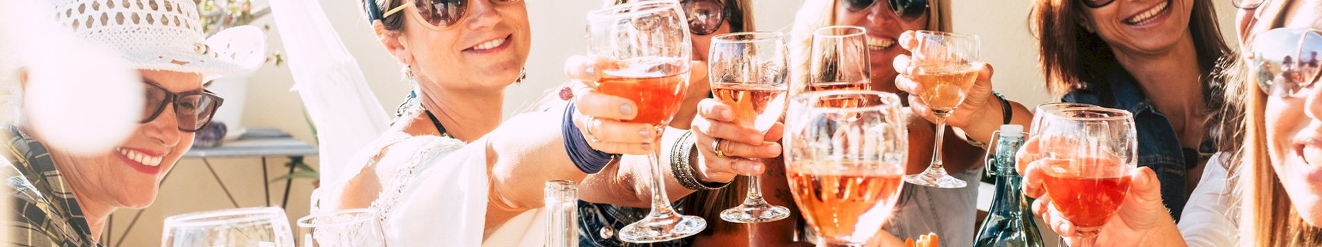 Six girls enjoying glasses of wine on there hen weekend.