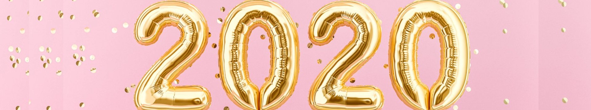 Gold balloons spelling out 2020 with gold confetti