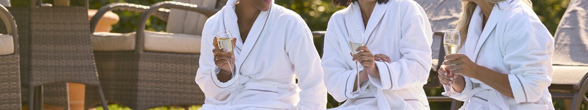 a group of 3 girls relaxing by the pool at a european spa on a hen do 
