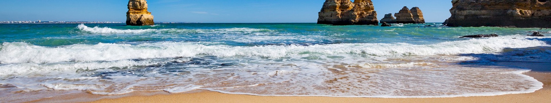 A beach with Albufeira written on 