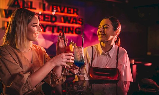 Two ladies enjoying cocktails 