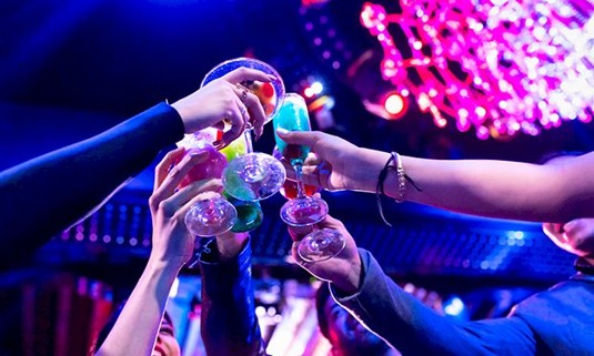 An image of glasses cheering in a nightclub.