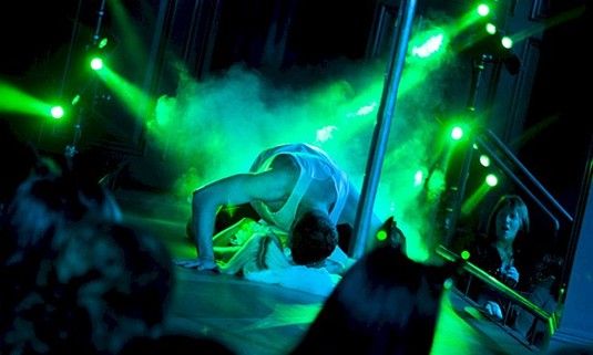 A topless man dancing on a lady 