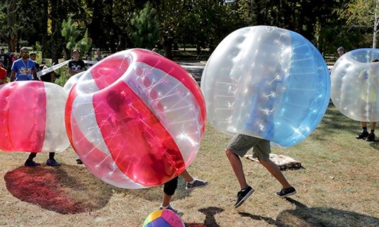 A group of people taking part in bubble football.