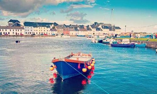 Boat docked in the deep blue waters of the River Corrib. Explore Galway Hen Party ideas below: