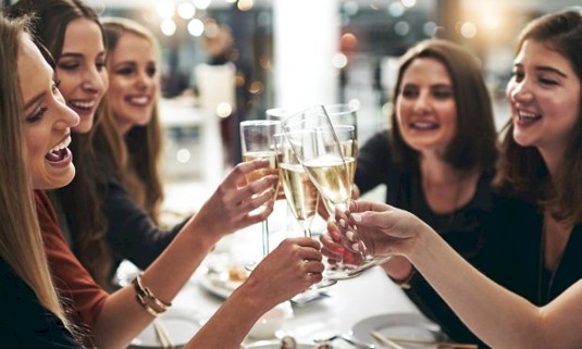 Girls with prosecco at dinner