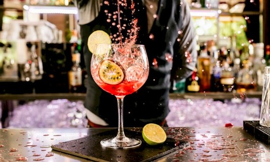 Cocktail being poured into glass 
