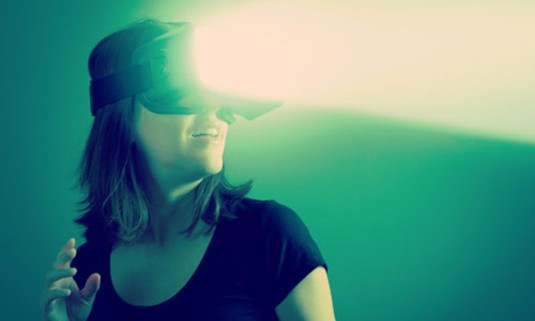 Woman wearing VR goggles in a dark room. Discover the Lincoln Virtual Reality Rooms hen party experience: