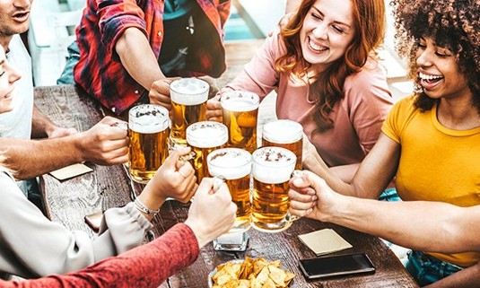 Five ladies enjoying large pints of beer.