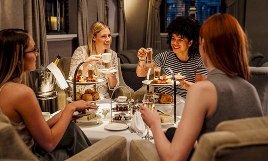 Four ladies enjoying afternoon tea.