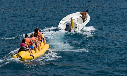 4 people enjoying a banana boat.