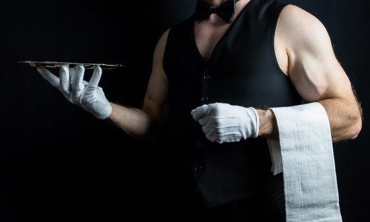 An Attractive man serving dinner in little clothing