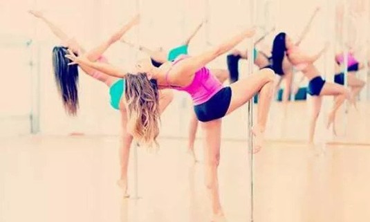 Women in a pole dance lesson as a hen do activity in Paris