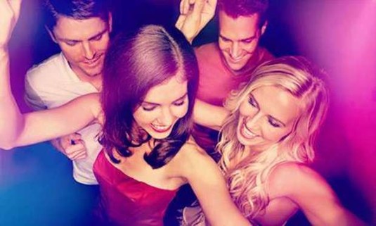 Two girls and two guys dance in a dark nightclub. Discover Prague Nightclub Tickets for your hen night: