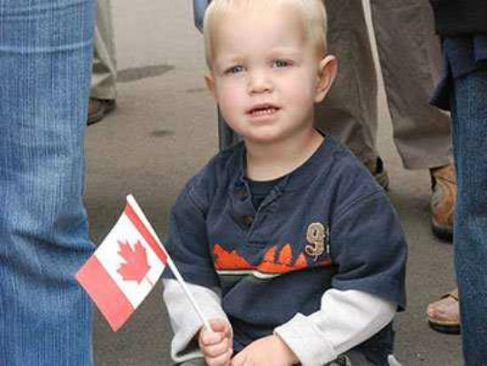kid holding canadian flag